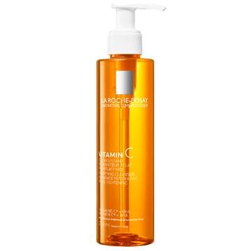Orange bottle with white pump of La Roche-Posay skincare product on a white background
