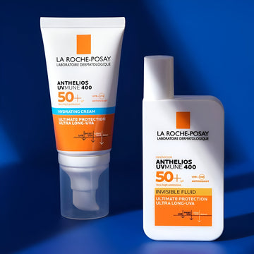 La Roche-Posay Anthelios UVMune 400 Hydrating Cream and La Roche Posay Anthelios UVMUNE 400 Invisible liquid front shots, side by side on a blue background.