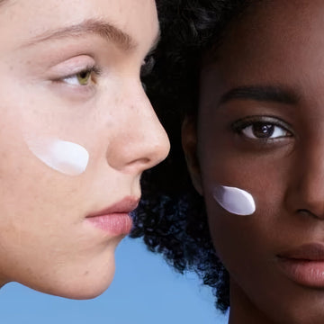 two models with cream on their face